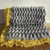 grey blanket with yellow trim img